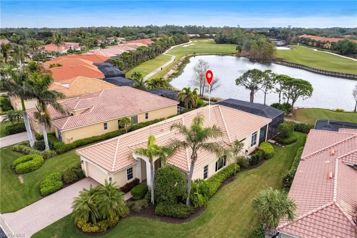 Aerial perspective of suburban area with a large body of water and a golf club