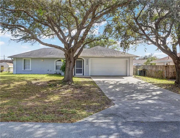 Single story home with a front yard and a 2 car garage