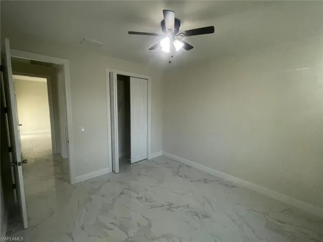 Unfurnished bedroom with tile floors, a closet, and ceiling fan