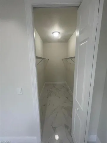Walk in closet with tile floors