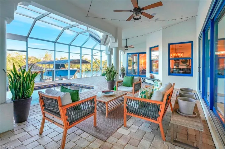 Sunroom featuring a water view and ceiling fan