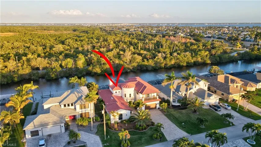 Birds eye view of property with a water view