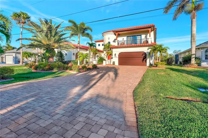 Mediterranean / spanish-style home with a front lawn and a balcony