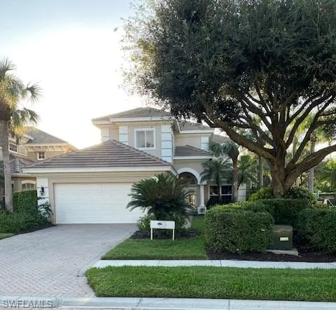 View of front of home featuring a garage and a front yard
