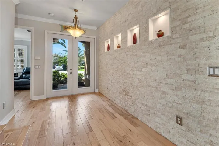 When you enter this home, the stone wall compliment the engineered scraped birch flooring.