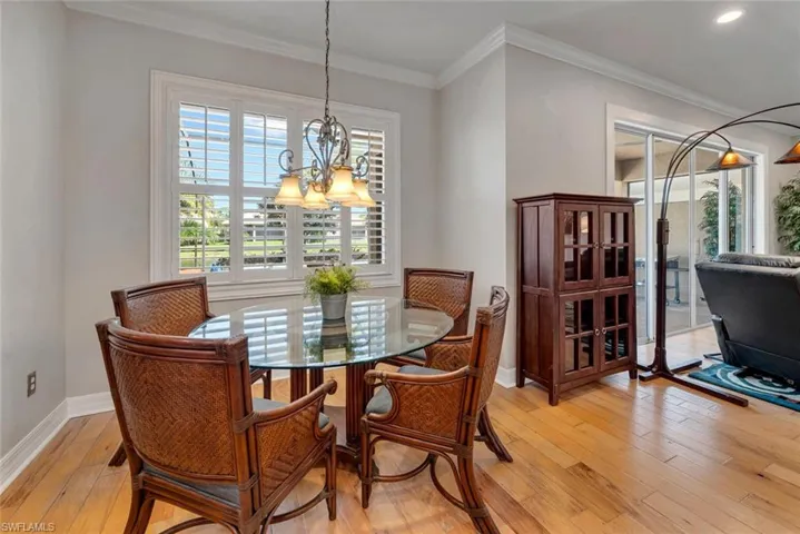 The dining area is part of the kitchen and opens to the Great Room. Note the view of the pool and Lanai.