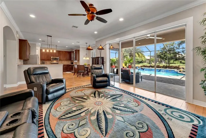 Great room opens to  the lanai and custom pool.