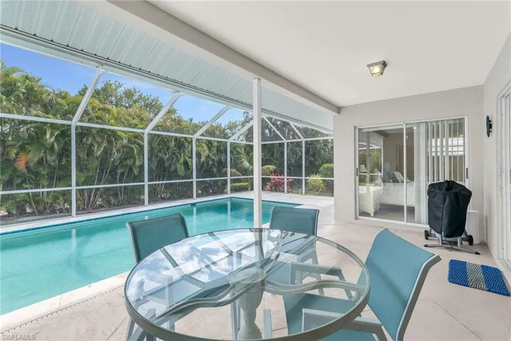 Outdoor pool featuring outdoor dining space, a lanai, and a patio area