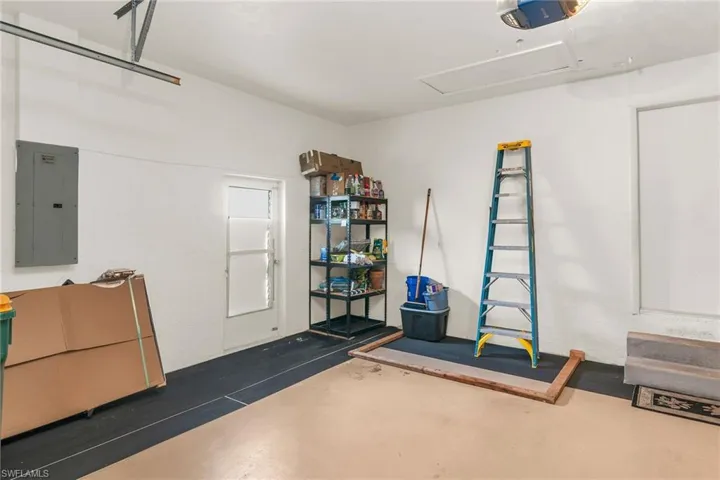 Garage featuring electric panel and a garage door opener