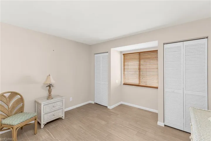 Sitting room featuring baseboards and light wood-style flooring