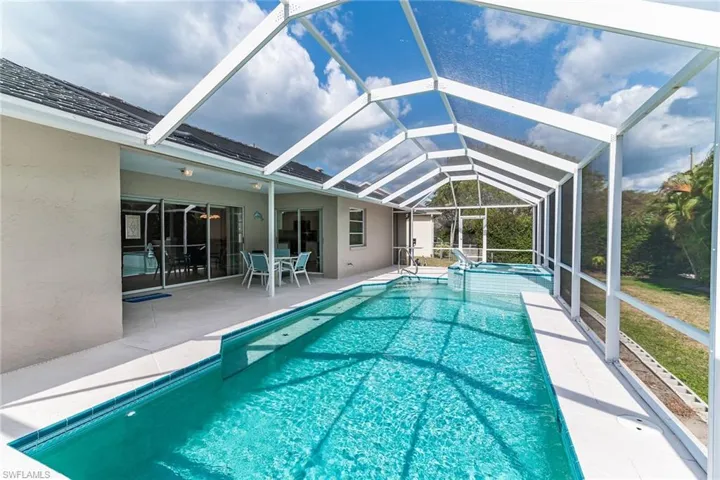 Pool featuring a lanai and a patio area