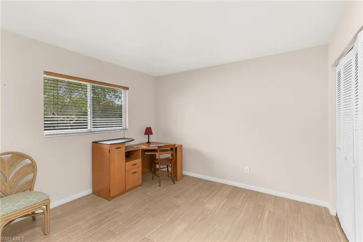 Office space featuring baseboards and light wood finished floors