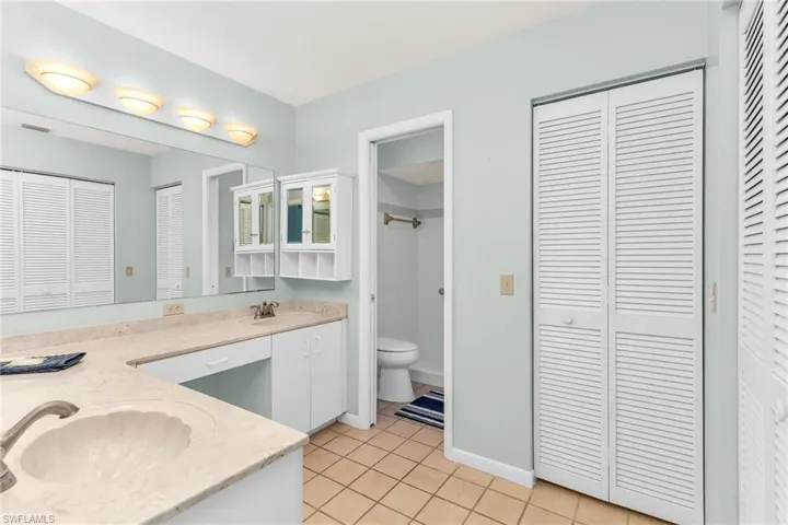 Full bathroom featuring toilet, a closet, and a sink