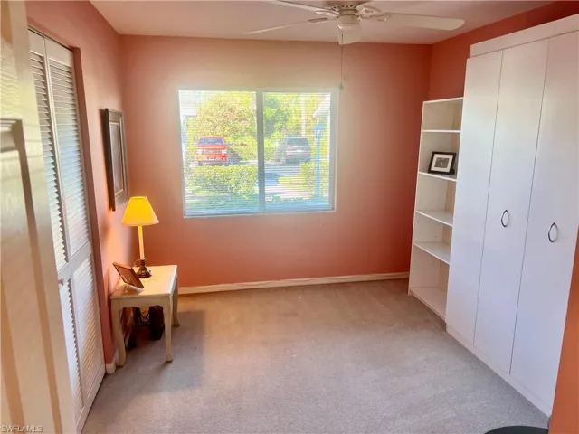 Unfurnished bedroom with light colored carpet and ceiling fan