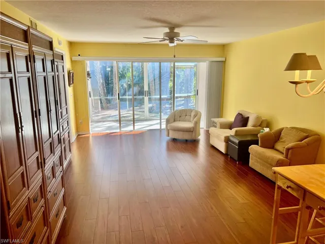Living room featuring hardwood / wood-style floors and ceiling fan