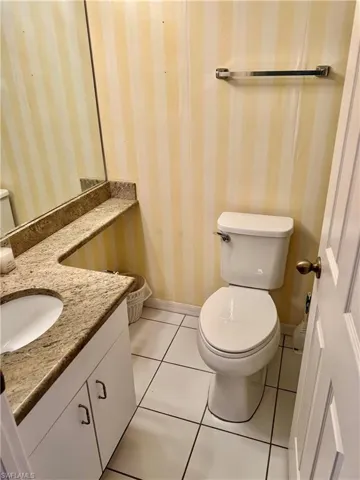 Bathroom with tile patterned flooring, vanity, and toilet