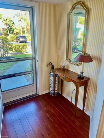 Entryway featuring dark wood-type flooring and a healthy amount of sunlight