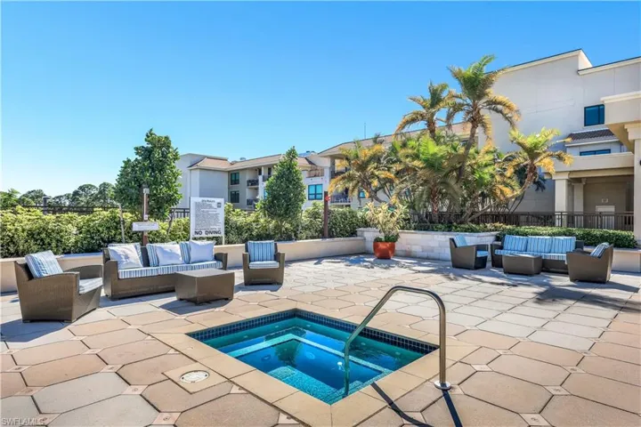 View of pool featuring an outdoor living space, a patio area, and a hot tub
