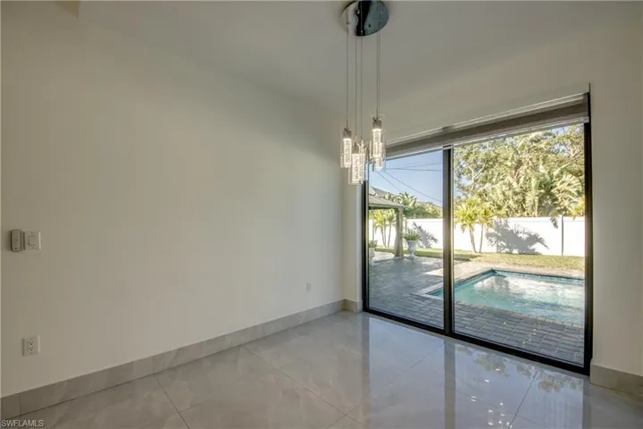 Unfurnished room featuring a chandelier