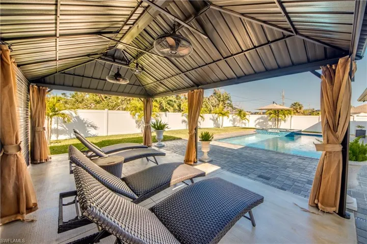 View of patio / terrace with a fenced in pool, a gazebo, and ceiling fan