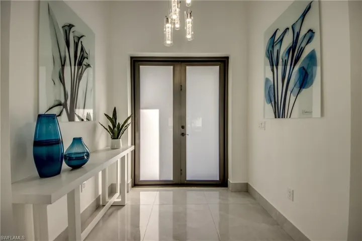 Entryway featuring a notable chandelier and french doors