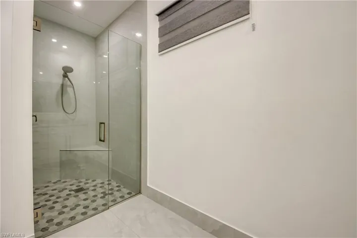 Bathroom featuring a shower with door