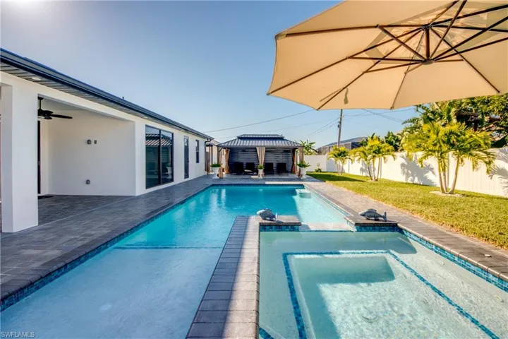 View of swimming pool with a gazebo, ceiling fan, a patio, and a lawn