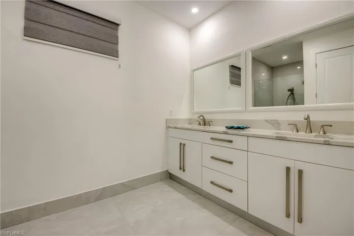 Bathroom featuring walk in shower and vanity