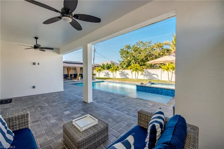 View of pool featuring a patio, outdoor lounge area, and ceiling fan