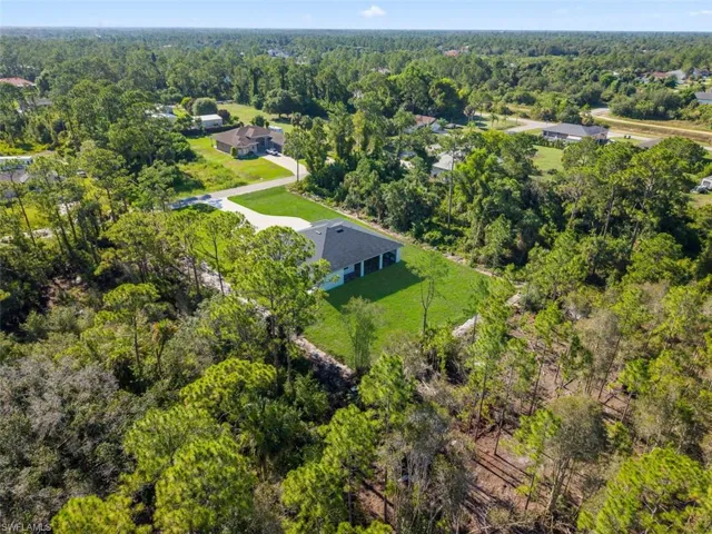 Newly constructed single-story residence featuring a dark shingle roof and light-colored siding