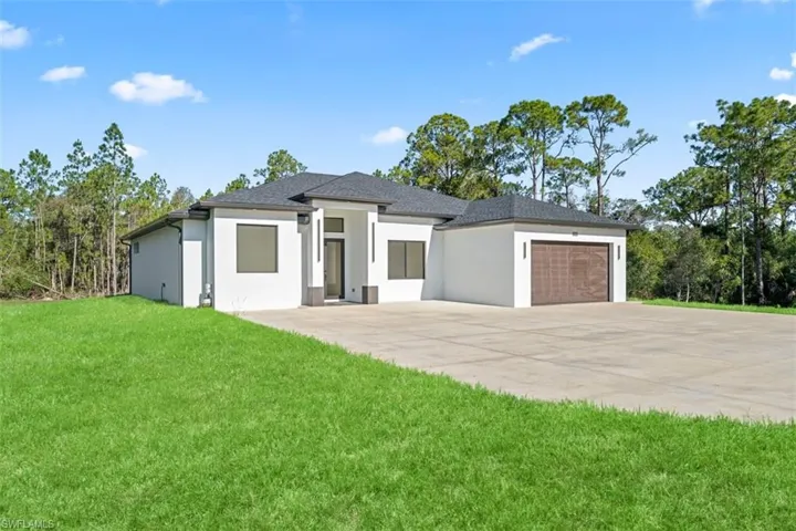 Modern white stucco exterior with a dark shingle roof