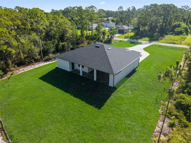 Contemporary single-story residence with a dark shingle roof and white exterior walls