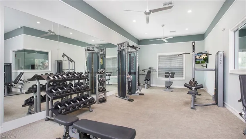 Community workout area with ceiling fan and carpet