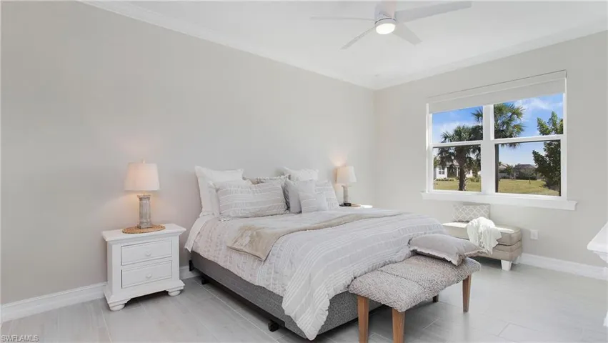 Main bedroom featuring ornamental molding and ceiling fan