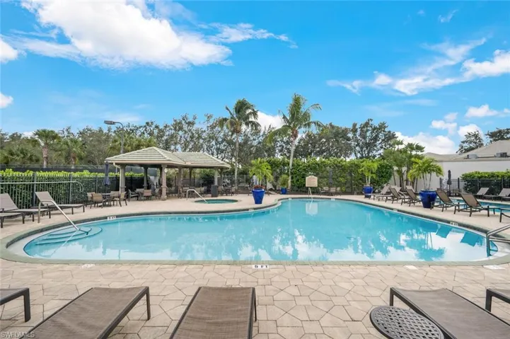 Pool featuring a community hot tub, a patio, a gazebo, and fence