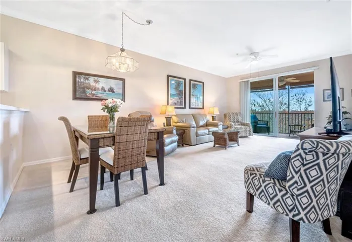 Dining space with crown molding, baseboards, and ceiling fan with notable chandelier