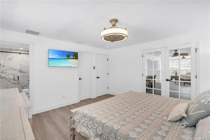Bedroom featuring french doors to Florida Room - VIRTUALLY ENHANCED