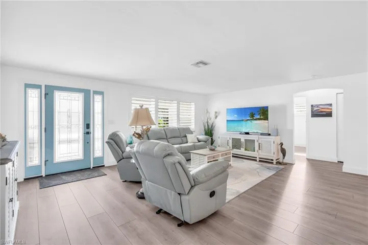Living room featuring light wood-type flooring - VIRTUALLY ENHANCED