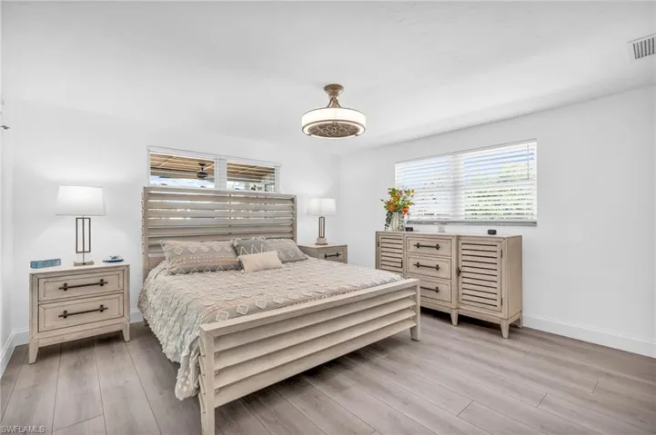 Bedroom with light hardwood / wood-style flooring - VIRTUALLY ENHANCED