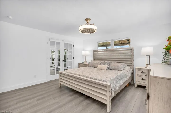 Bedroom featuring french doors to Florida Room - VIRTUALLY ENHANCED