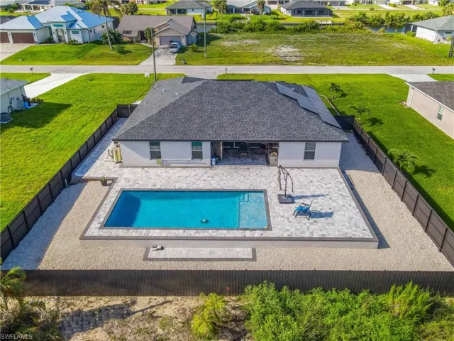 View of swimming pool with a patio and a lawn