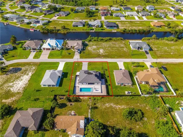 Birds eye view of property with a water view