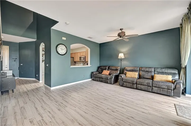 Living room featuring ceiling fan and light wood-type flooring