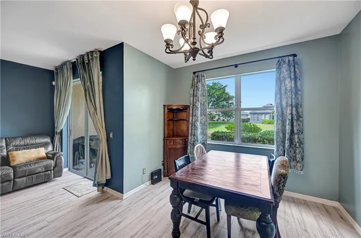 Dining space with a chandelier and light hardwood / wood-style flooring