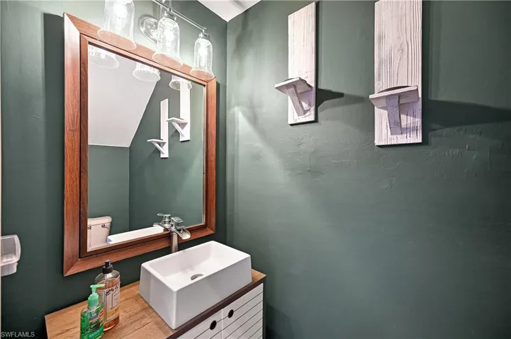 Bathroom with hardwood / wood-style flooring, vanity, and toilet