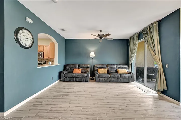 Unfurnished living room with light hardwood / wood-style flooring and ceiling fan