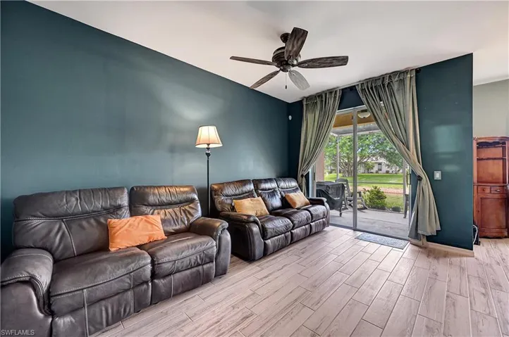 Living room featuring light hardwood / wood-style flooring and ceiling fan