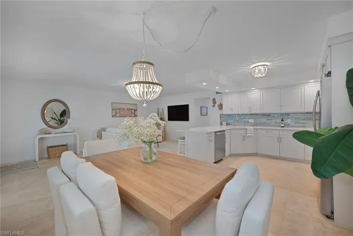 Dining area featuring recessed lighting, a chandelier, and light tile patterned flooring