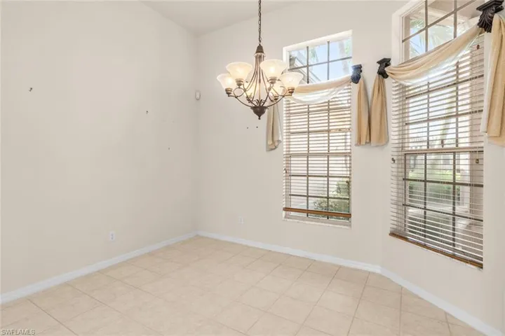dining room  room featuring a healthy amount of sunlight and an inviting chandelier