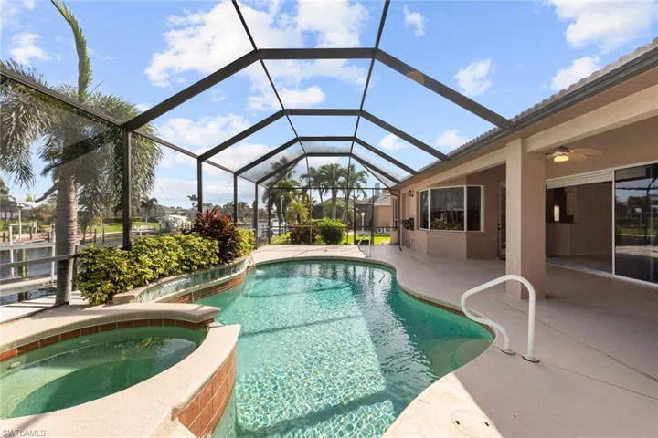 View of swimming pool with a lanai, an in ground hot tub, a patio, and ceiling fan
